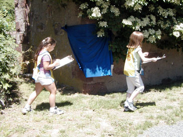 Two participants run past dark blue flag.