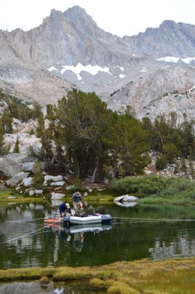 Scott Mensing from the University of Nevada-Reno works with undergraduate students Austin Bassett and Scott Wright to take sediment cores from one of the Baboon Lakes.
