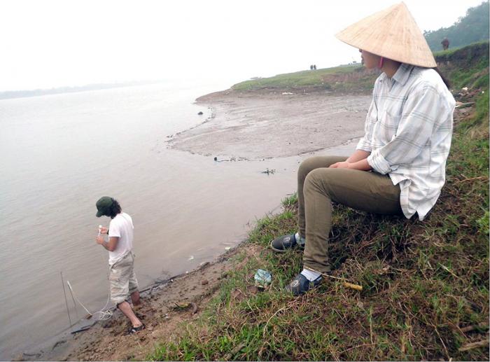 Mason Stahl tests arsenic concentrations in slow-moving water along the edge of the Red River near Hanoi, Vietnam.