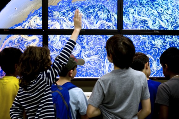 Student visitors in front of the Core Repository Hyperwall, an education and outreach tool made possible by support from the Advisory Board Innovation Fund.