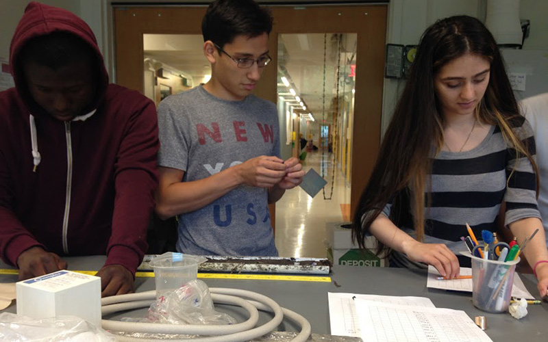 High school students work on a core sample as part of the Secondary Schools Field Research Program. (John Bjornton)
