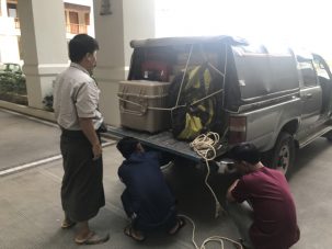 Our driver, Win Htut, tying up the back of the truck with rope.