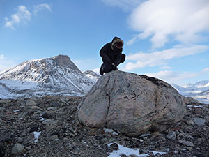 In Baffin Island’s Naqsaq Valley, University at Buffalo geologist Jason Briner samples a boulder left by a glacier around the time of early Viking settlement. Measurements of chemical isotopes within the rock suggest settlers in neighboring Greenland faced cold weather. (Nicolás Young)
