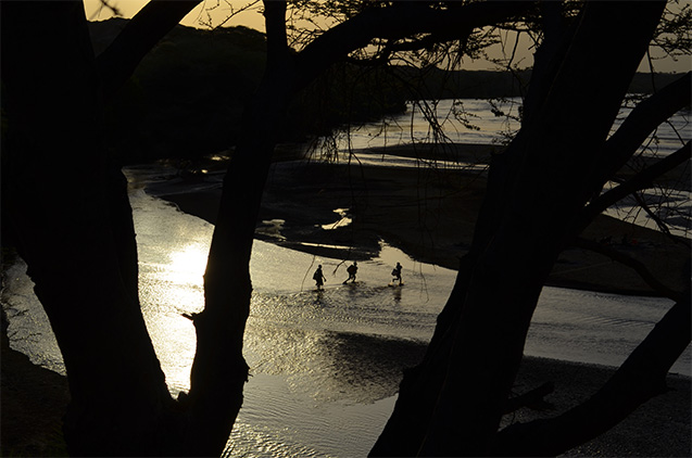 Humans probably evolved amid the changing landscapes of east Africa; a new record of vegetation over millions of years provides new context. Here, boys cross the Turkwel River in northwest Kenya, where many key fossils have been found. (All photos: Kevin Krajick)