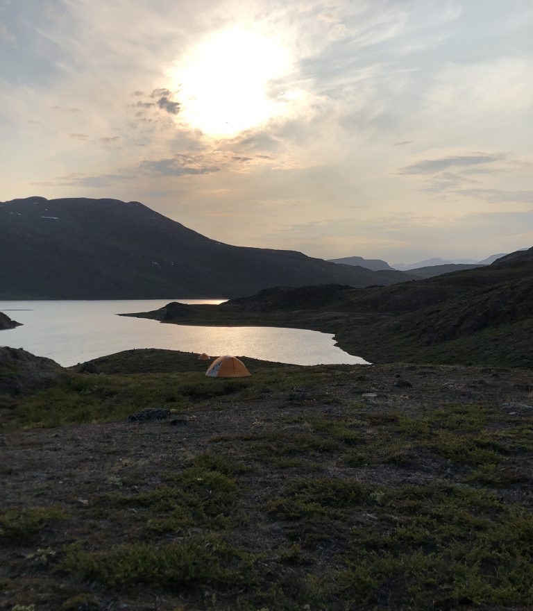 One in a chain of lakes feeding into Lake Gus; both bodies of water are unnamed on local maps and are situated west of Kangerlussuaq and east of Sisimiut, Greenland. Several of our tents are visible in the foreground. (M. Turrin)