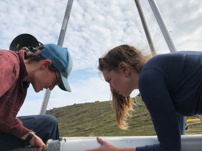 Elizabeth Thomas and Allison Cluett work on the piston corer in preparation for deployment. (M. Turrin)