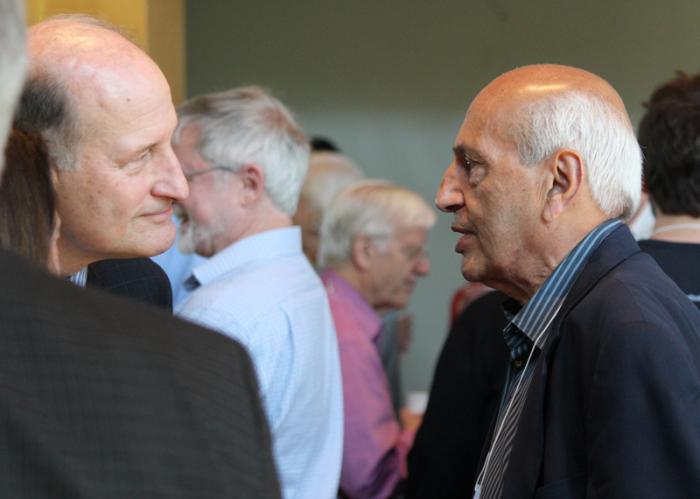 Former Lamont Director Manik Talwani, right, speaks with geologist Roger Buck during a break at the symposium.